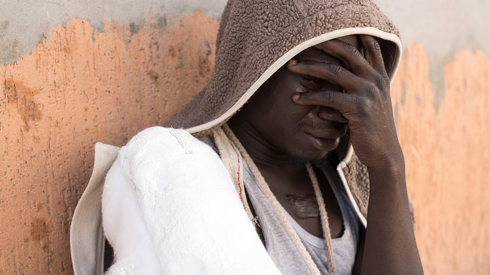 Ein Flüchtling weint, nachdem er von der italienischen Einwanderungspolizei angehalten wurde.  © Taha Jawashi