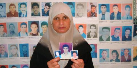 Une femme algérienne montre les photos de ses proches disparus © Amnesty International 