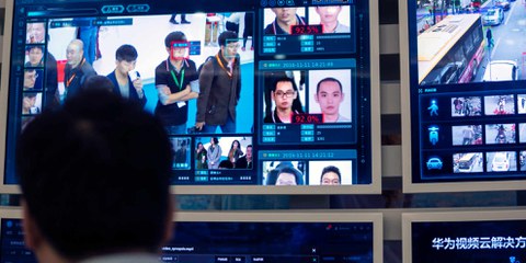 Un employé de Huawei fait la démonstration d'une technologie de reconnaissance faciale et de localisation. ©Keystone/EPA/Aleksandar Plavevski