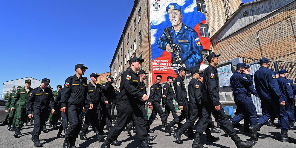 A Krasnoïarsk, en Russie, des soldats passent devant un graffiti à la mémoire du parachutiste russe Vladislav Razumov, tué pendant la guerre en Ukraine.© IMAGO/SNA/Ilya Naymushin