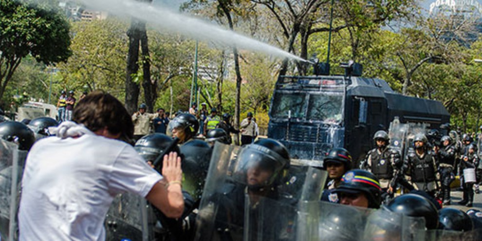 Le forze di sicurezza usano gli idranti contro i manifestanti a Caracas. | © Carlos Becerra