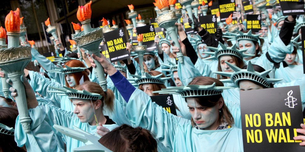 Un centinaio di statue della libertà hanno sfilato davanti all’Ambasciata statunitense a Londra, il 27 aprile 2017, per segnare i primi 100 giorni della presidenza Trump. © Marie-Anne Ventoura/Amnesty UK