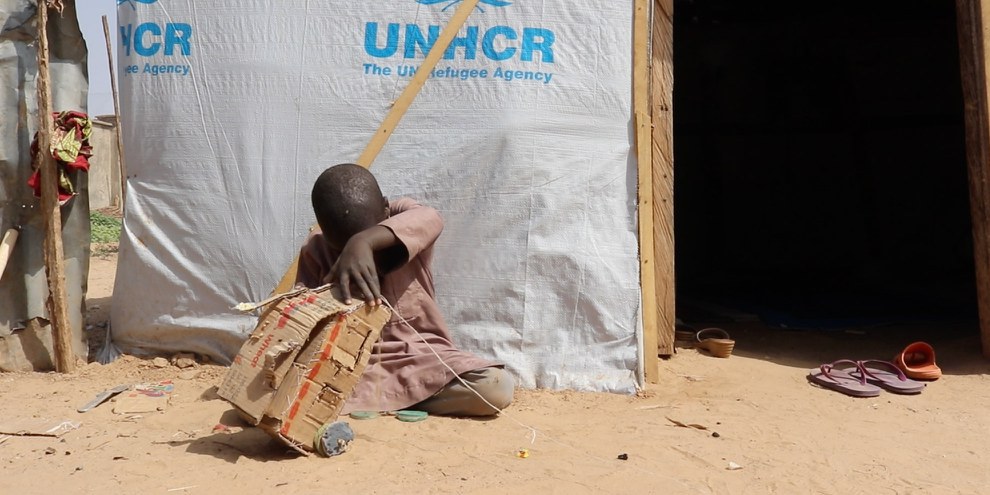 Un ragazzino gioca fuori dal suo rifugio in un campo per sfollati fuori Maiduguri, nello Stato di Borno, Nigeria, nel gennaio 2020. Più di due milioni di persone sono sfollate all'interno del paese a causa dell'annoso conflitto tra l'esercito nigeriano e Boko Haram. © AI